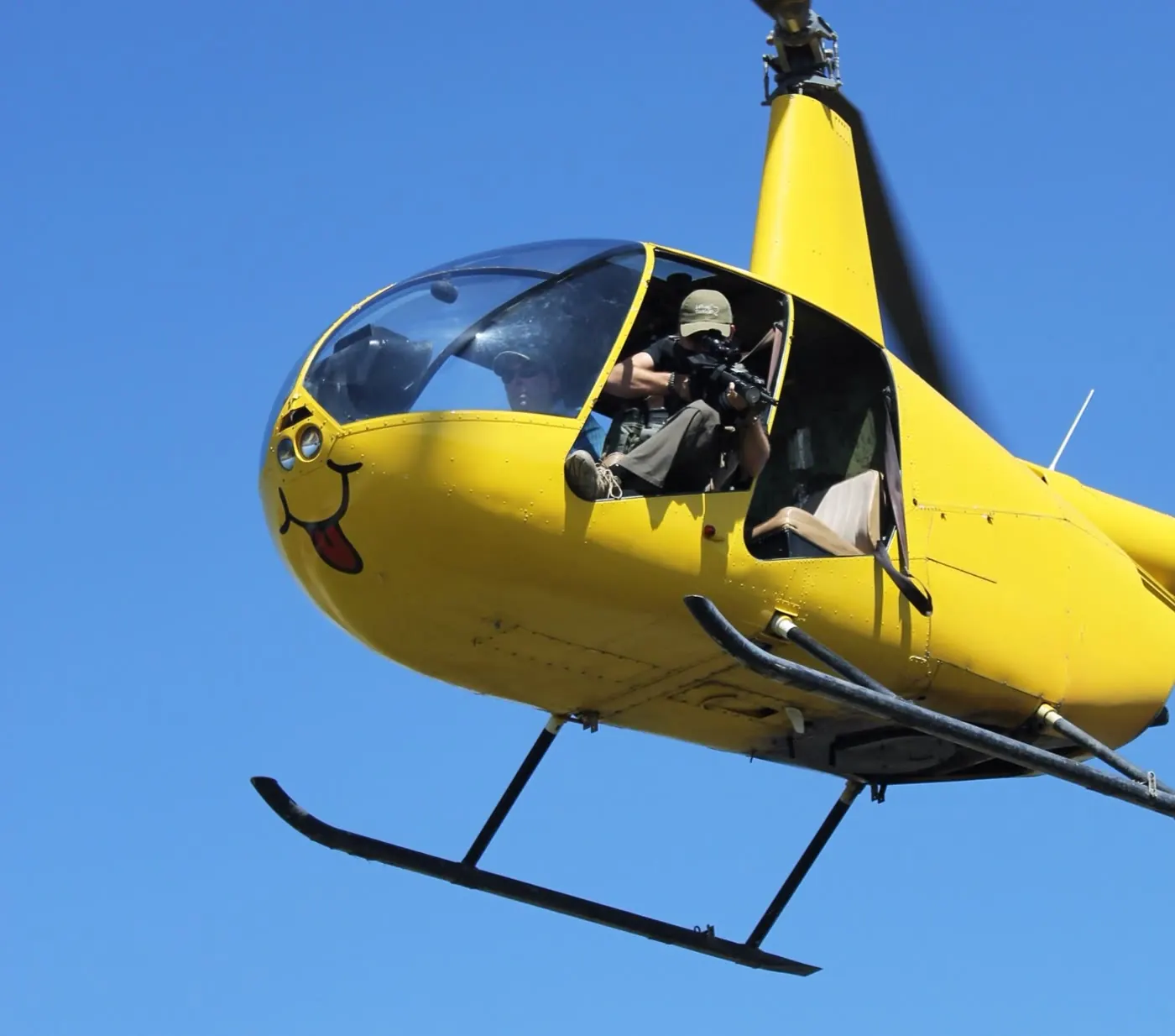 Hunter in a helicopter on an aerial hog hunt over the ranch