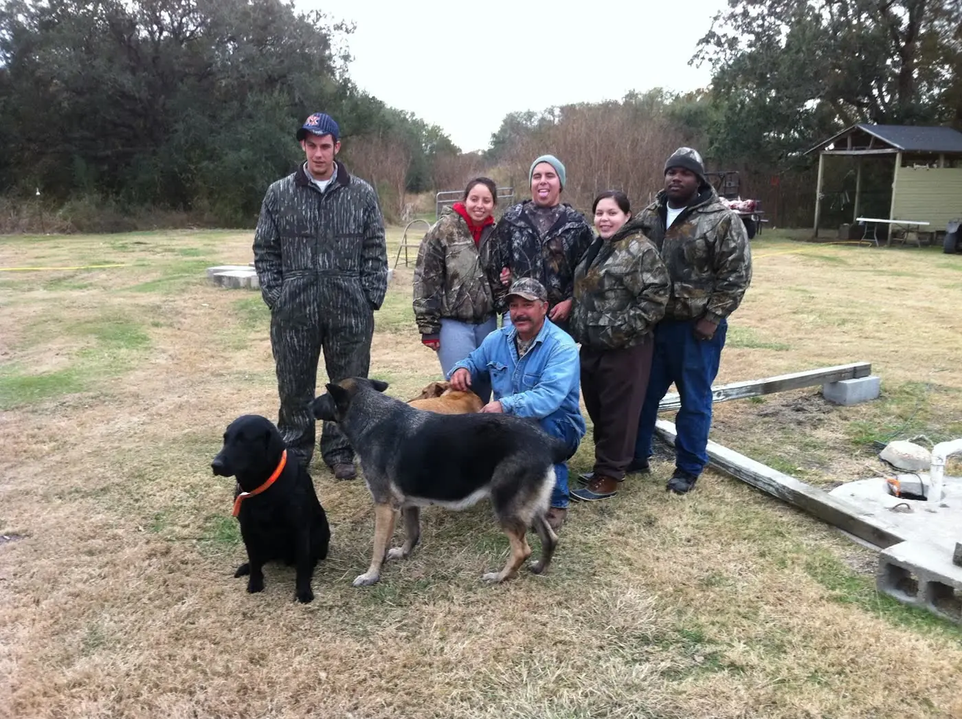A group of hunters with their dog after a successful day at JB Hunting Ranch